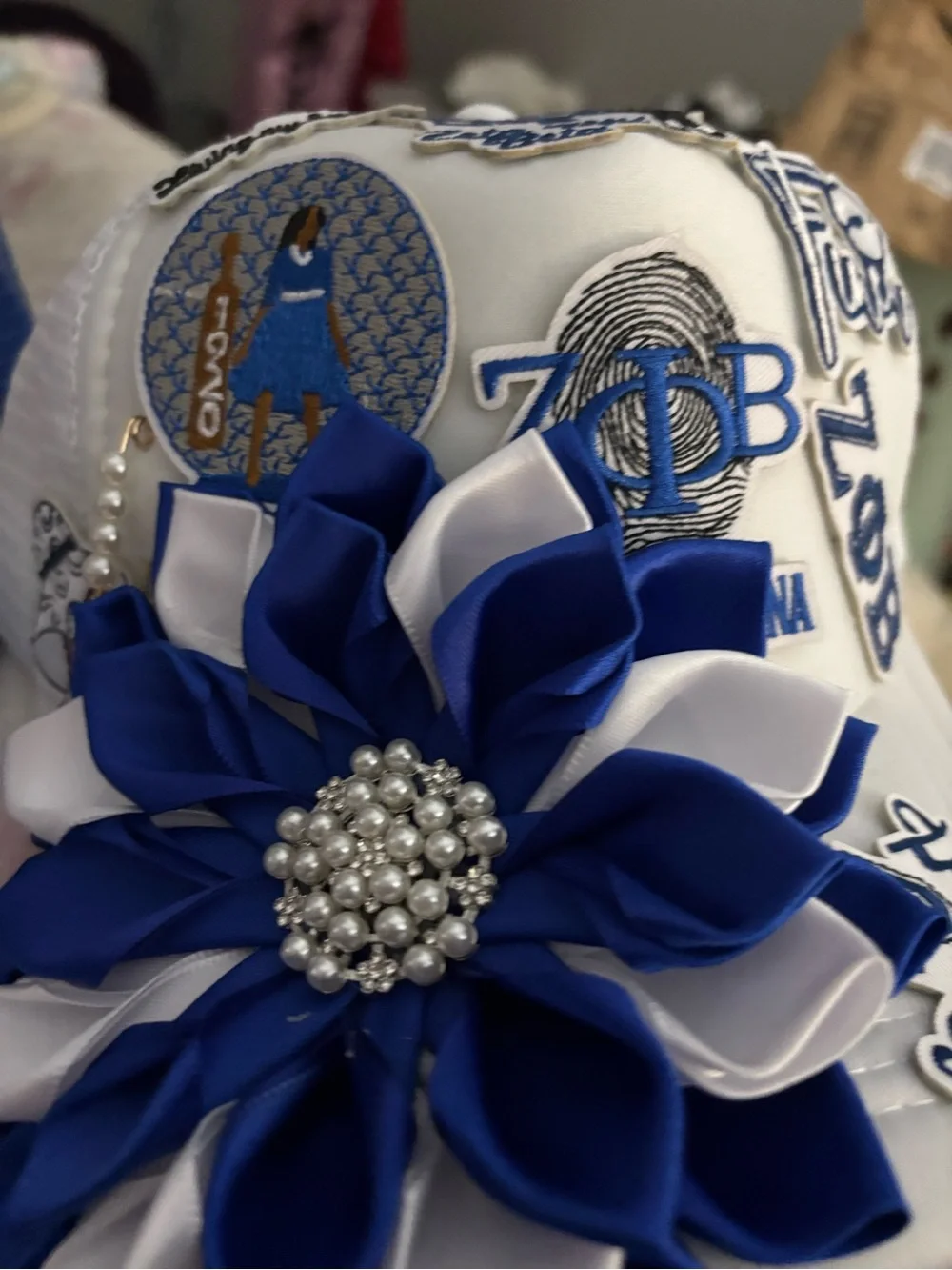 White Hat with Blue & White Flower Appliqué